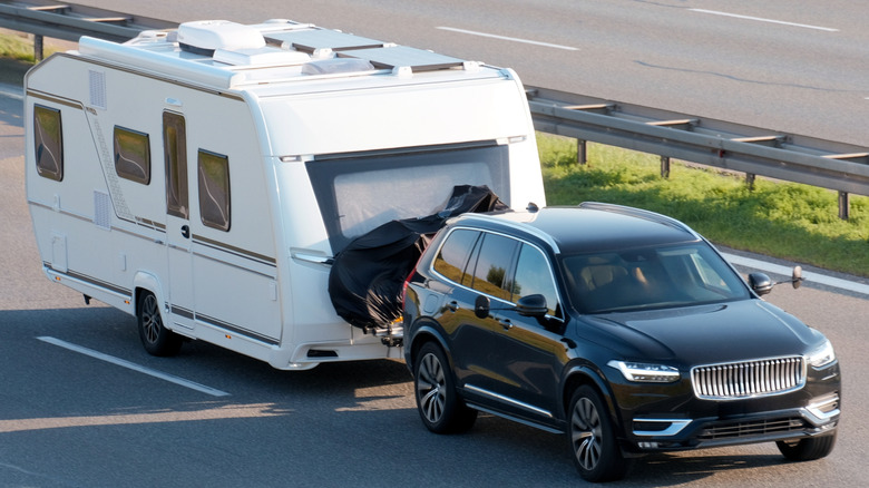 A mid-size SUV towing a camper